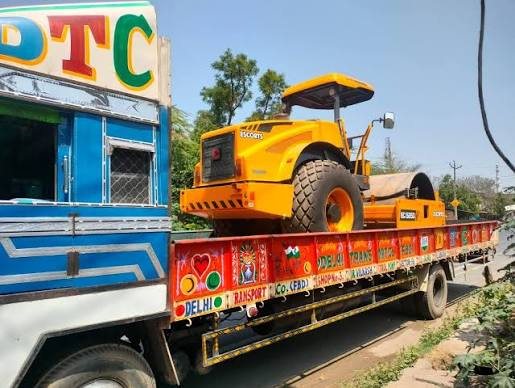 A road roller loaded on a platform truck ready for transport