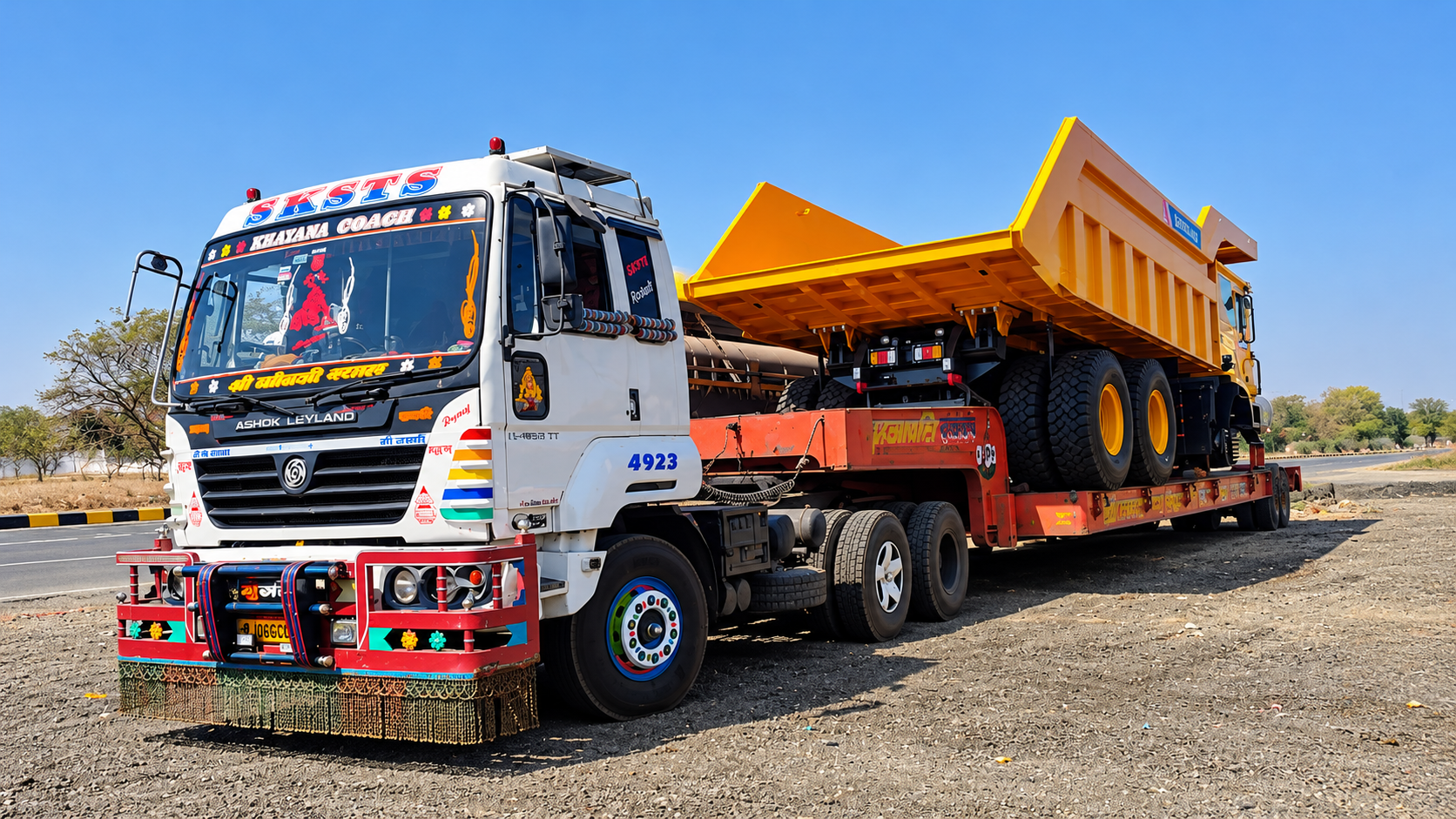 An Ashok Leyland low bed trailer hauling a heavy earth mover