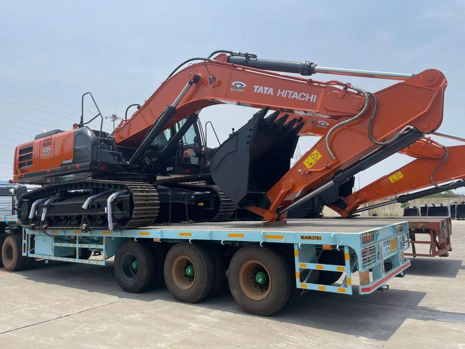 A Hitachi excavator loaded on a multi axle low bed trailer